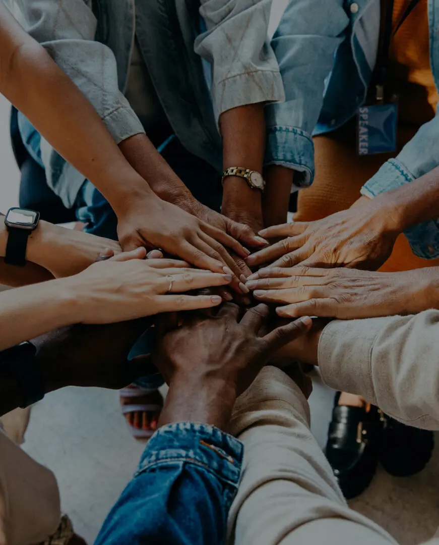 Diverse group joining hands