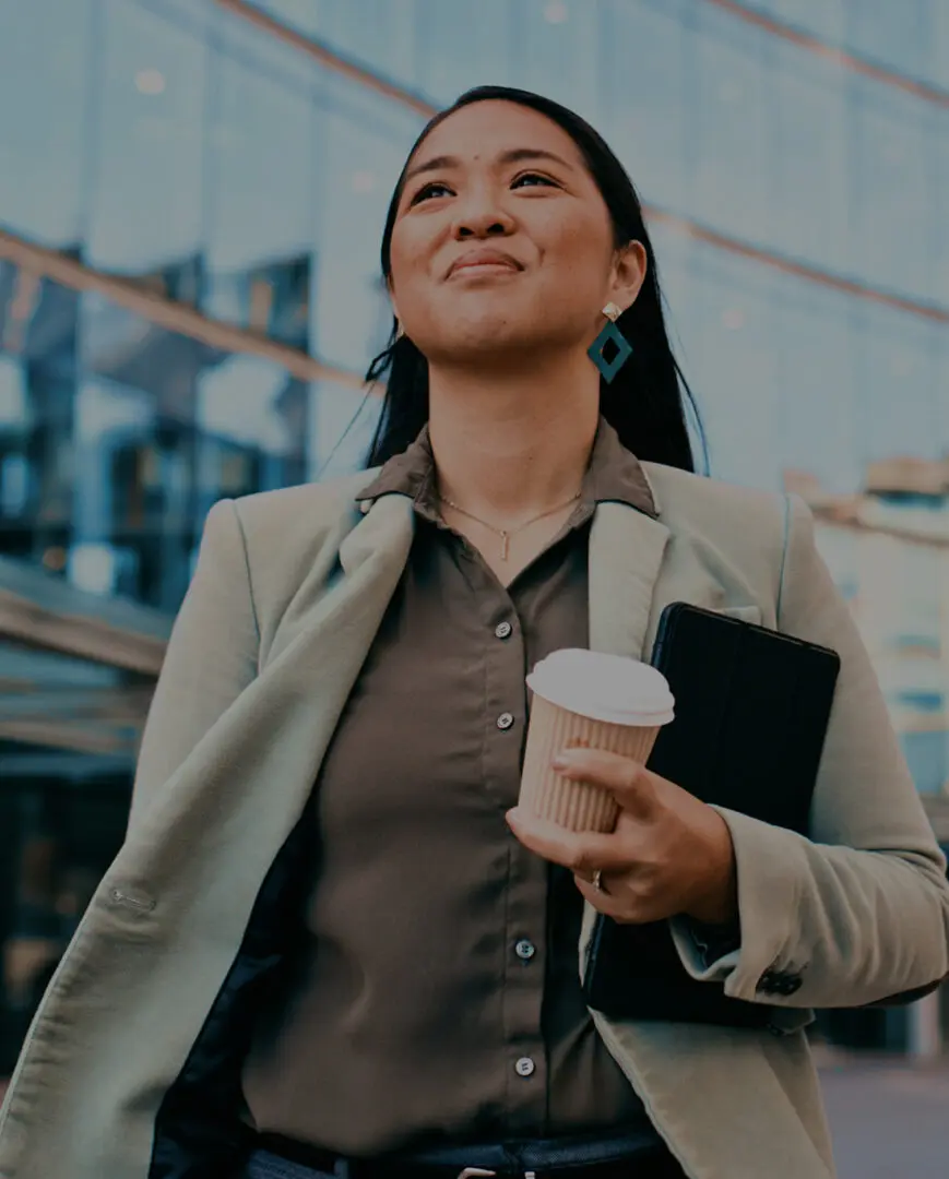 Confident woman with coffee and tablet.