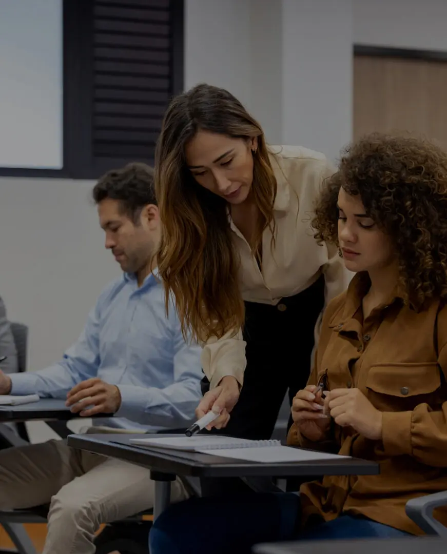 Instructor assisting learners in a lecture hall